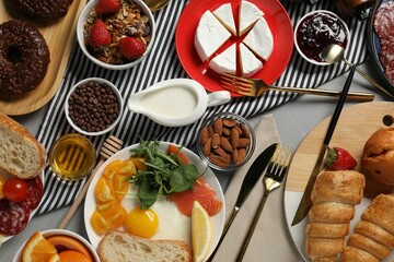 Different tasty food served for brunch on grey table, flat lay