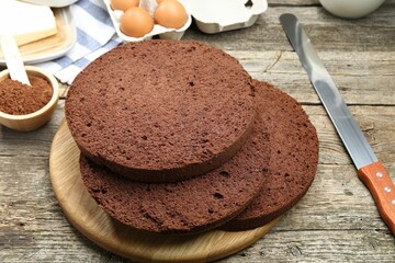 Cut chocolate sponge cake and ingredients on wooden table