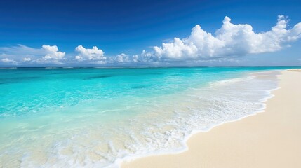 Obraz premium A serene beach scene with turquoise waters and soft white sand under a bright blue sky.