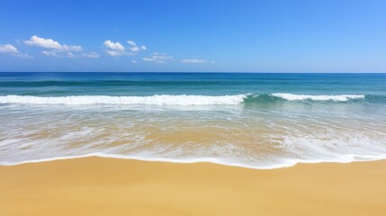 Naklejka premium A serene beach scene with golden sand and gentle waves under a clear blue sky.
