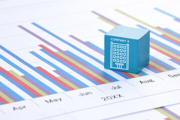 会社のアイコンが描かれたブロックとビジネスチャート