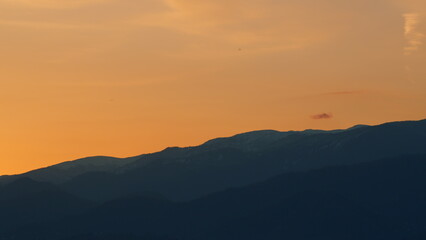 Obraz premium Sunrise Background Over The Mountain. Mountains Silhouette And Cloud. Pan.