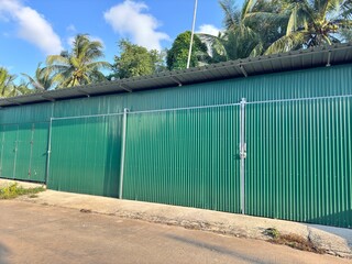 galvanized iron for fences. Green galvanized wall. A wall made of green corrugated sheet metal....