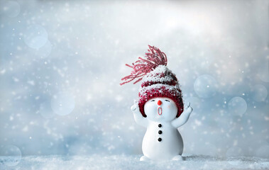One little snowmen in caps on snow in the winter. Background with a funny snowman. Christmas card.