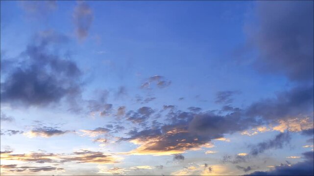 Yellow to orange cirrus and cumulus clouds on sunset background 
