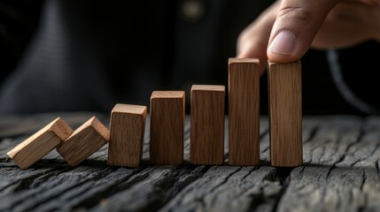 Hand placing wooden blocks in ascending order, symbolizing growth and progress.