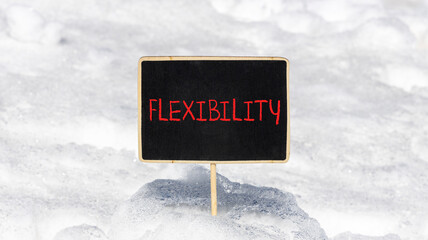 Flexibility symbol. Concept word Flexibility on beautiful chalk blackboard. Beautiful white snow...