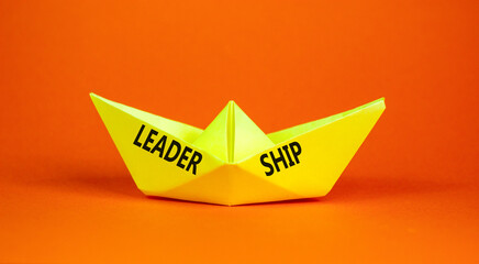 Leadership symbol. Concept word Leadership on beautiful yellow paper boat. Beautiful orange...