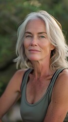 An older woman looks confidently off-camera while enjoying her outdoor workout