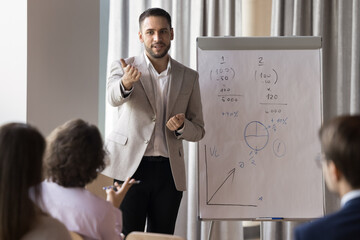 Engaged confident handsome business coach giving workshop, seminar, presentation, getting question...