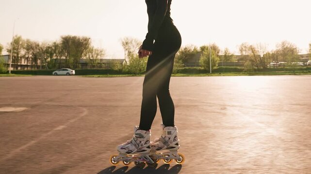 Slim Woman with Beautiful Figure Rollerblading in City Park, Enjoying Hobby and Feeling Free and Energetic. Concept of a Slim Female Body. Slow Motion