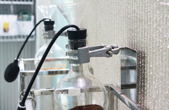 Universal clamp with round bottom flask background.