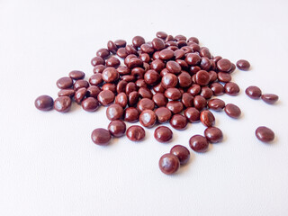 Chocolate coated peanut candy or chocolate balls isolated on white background