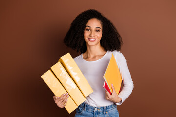 Portrait of nice young woman hold folders book wear pullover isolated on brown color background