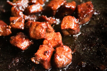 pieces of beef steak being grilled