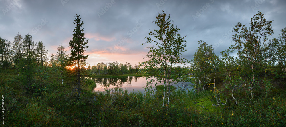 Poster a serene landscape with a lake and trees in the background. the sky is cloudy and the sun is setting