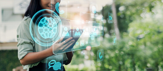 Business woman working outdoors with digital wireless communication technology concept, using ...