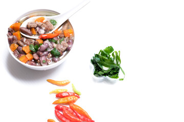 Sup daging kacang merah, clear soup with beef slices, red bean and vegetables. Served in bowl on white background. Selected focus