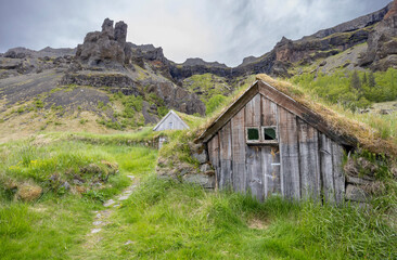 path leads along the turf outhouses at Núpsstaður, South Iceland, near Mt. Lómagnúpur
