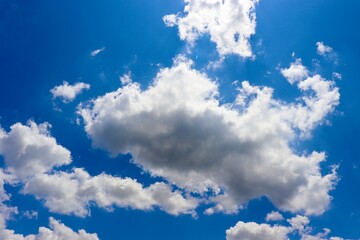 The puffy clouds in the bright blue sky.