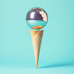 Disco ball ice cream on bright blue background. Minimal party concept.