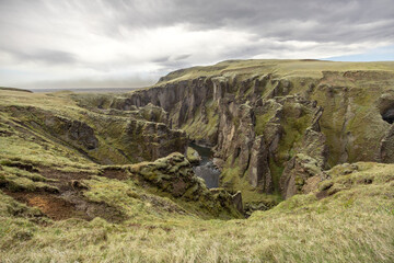 deep green mossy canyon with river in the mountains, Fjaðrárgljúfur canyon, South Iceland