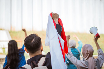 Youth activists passionately demonstrate with colorful flags and a megaphone for change