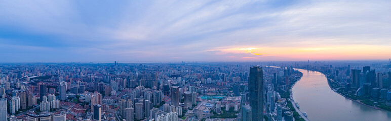 Aerial view of modern city skyline and buildings at sunrise in Shanghai