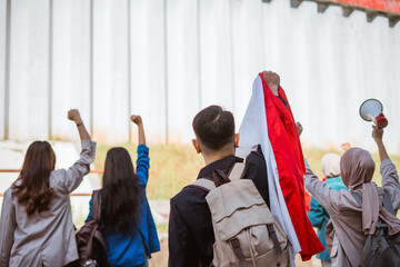 A group of young activists raises fists, expressing their solidarity and demands.