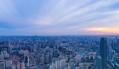 Aerial view of modern city skyline and buildings at sunrise in Shanghai