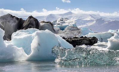 different types of icebergs -white, transparent, black, blue  in J&ouml;kuls&aacute;rl&oacute;n lagoon, Icleand
