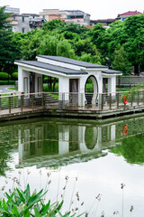 Scenery of Longhu Park in Sangyuan, Dongcheng District, Dongguan. Lake, plank road and Chinese pavilion.






