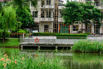 Fototapeta premium Scenery of Longhu Park in Sangyuan, Dongcheng District, Dongguan. Lake, trees and viewing platform.