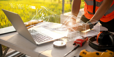 Architect engineer designing blueprint using computer mobile phone graphic hologram technology for innovation, workstation desk at construction site building project renovation property inspection