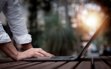 Businessman in casual look using laptop and working in startup business at cafe coffees shop in public locations ,work from home and anywhere meeting online, searching internet for job in social media