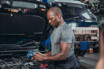Professional Auto Technician Servicing Car Air Conditioning
