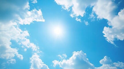 Bright Blue Sky with Fluffy Clouds and Sunlight