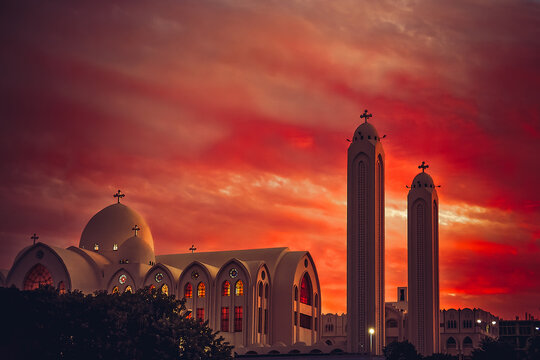 Dramatic red sunset over a Traditional Orthodox church, Aswan, Egypt