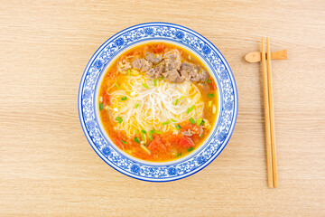 A bowl of tomato beef brisket sour soup rice noodles