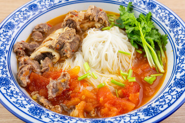 A bowl of tomato steak rice noodles