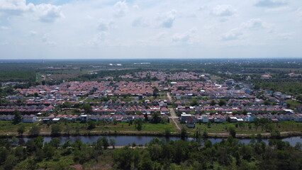 Dense housing neatly arranged with the texture of rice fields with a sunrise background