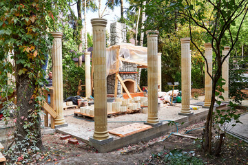 building a summer pergola with columns in the garden