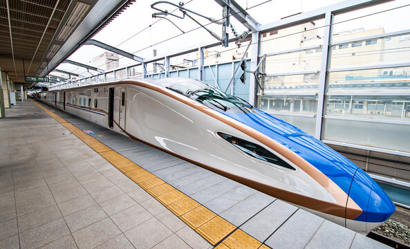 A JR E7 series Shinkansen bullet train stopping at Nagano Station The E7 series was launched in year 2014, and is serving in the Hokuriku Shinkansen in Nagano, Japan on Oct 7, 2014