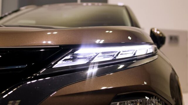 Close-up of advanced car headlight technology in a modern car interior. The sleek design illuminates the road, showcasing innovation and enhancing nighttime visibility.