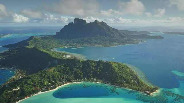 Breathtaking aerial panorama Bora Bora island green mountains and crystal clear turquoise lagoon. Idyllic tropical paradise. Luxury remote vacation, exotic travel destination. High angle drone flight