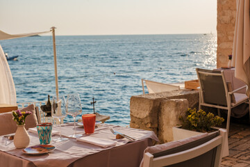 Dining by the sparkling Adriatic Sea in Rovinj, Croatia at sunset