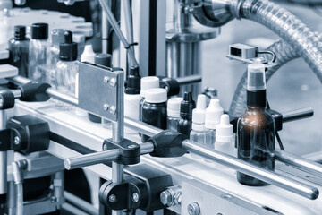 pharmaceutical industry, medicine pills are filling in the  bottle on production line machine conveyor at the medical factory. selective focus.