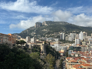 Panorama of historic architecture on the hill of the Prince's Palace in Monaco on the left and the rest of the city on the right.