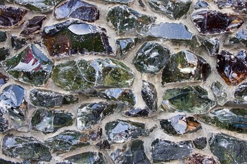 Glass fiber melt multicolored blocks cemented on facade concrete wall as modern architectural...