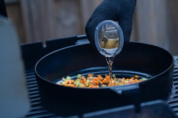 Brightly coloured vegetables and seafood grilling on the barbecue, offering a mouthwatering mix of...